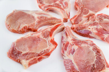 Wall Mural - Raw pork chops bone in isoladet on white background.