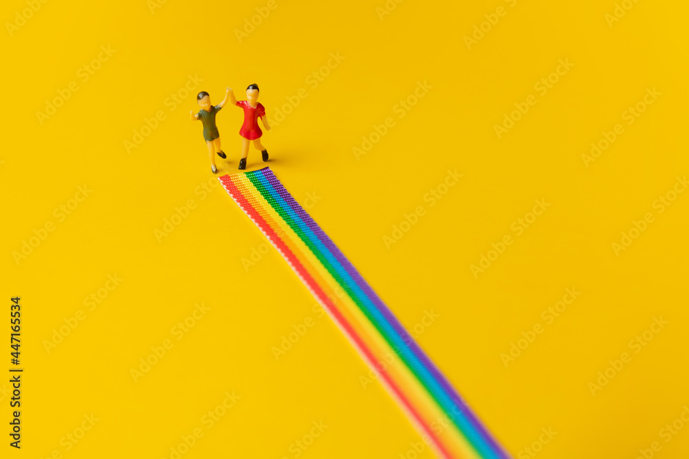 little girl and boy figures on the LGBT rainbow path - obrazy, fototapety, plakaty 