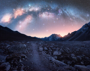 Wall Mural - arched milky way and mountains at night. beautiful landscape with bright milky way arch, rocky path,