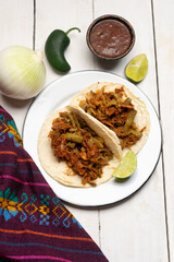 Mexican food. Chilorio and nopales tacos on white background