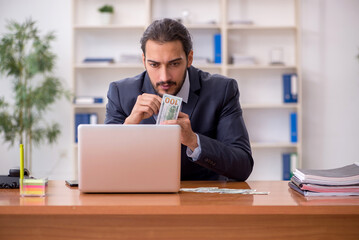 Wall Mural - Young male employee playing cards at workplace