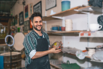 young adult potter with his pottery pieces