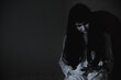 © sorapop - Woman ghost horror sitting her have knife arm in the house, halloween concept