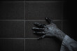 © sorapop - Hand of woman ghost creepy touch on wall have copy space for background, halloween day concept