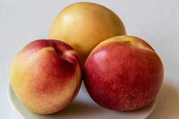 Wall Mural - Nectarine Fruits on a plate isolated on white background.