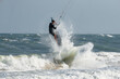 © Oleg - Kite surfer jumps with kiteboard in transition