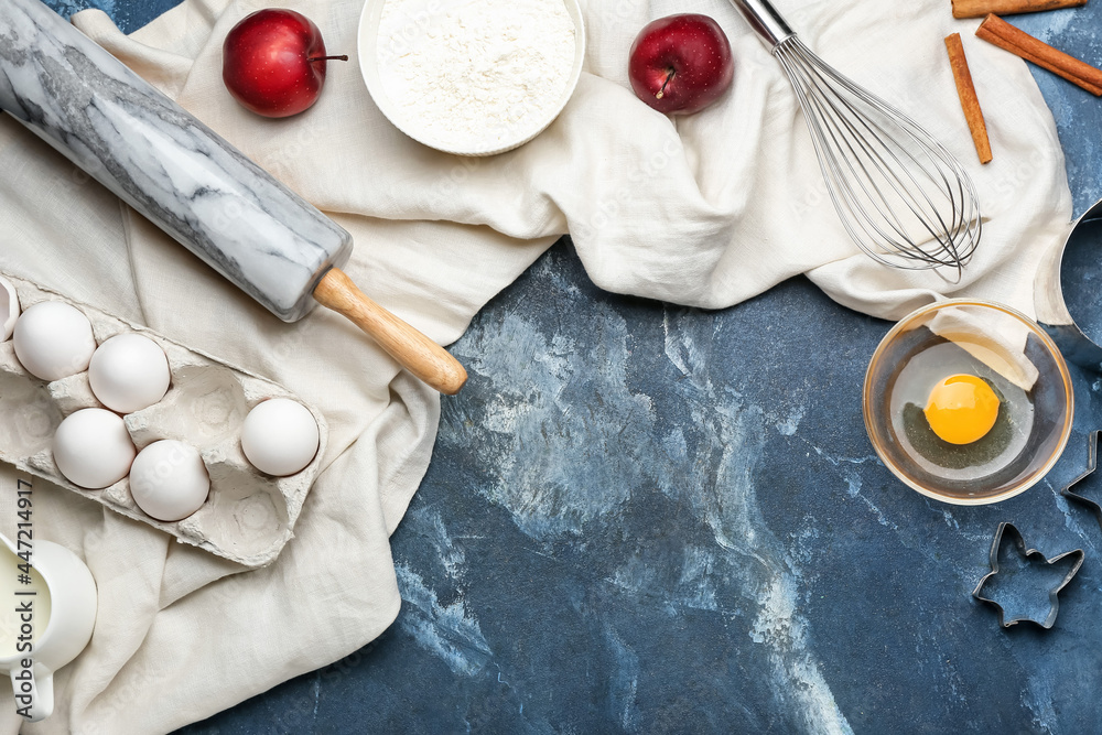 Ingredients for preparing bakery and utensils on color background
