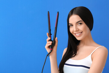 Poster - Beautiful young woman with flattening iron on color background