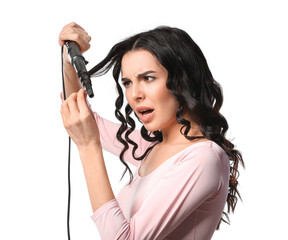 Poster - Stressed young woman with curling iron on white background