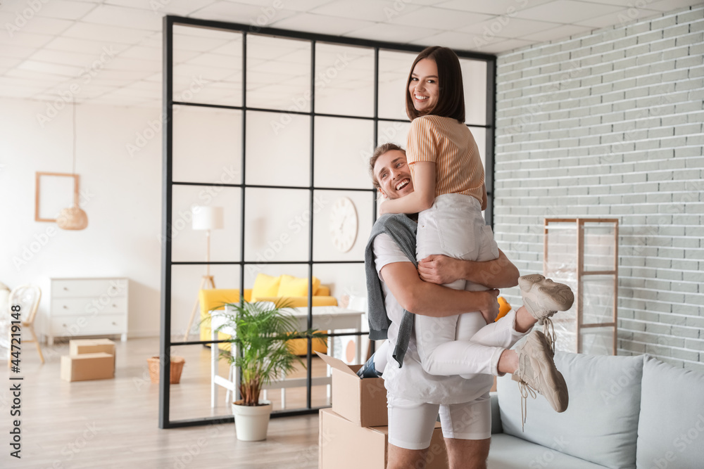 Young couple in their new house on moving day