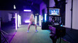 Fitness woman trainer record video on professional camera with neon lights