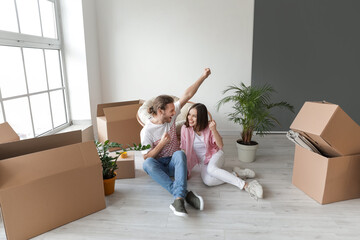 Sticker - Young couple with cardboard boxes in their new house on moving day