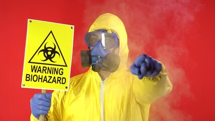 Wall Mural - Man in Protective Chemical Suit, Mask and Banner in Hands. Biological Protection. Smoke Around Man. Isolate, Studio. Protection concept, radioactive hazard concept