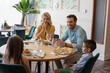© rilueda - Happy family having lunch together at the restaurant
