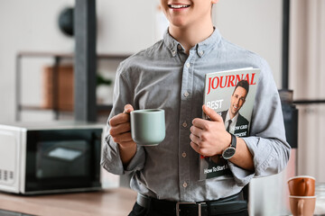 Poster - Young man with magazine drinking coffee in office