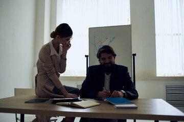 man and woman in the office at the desk, communication, work