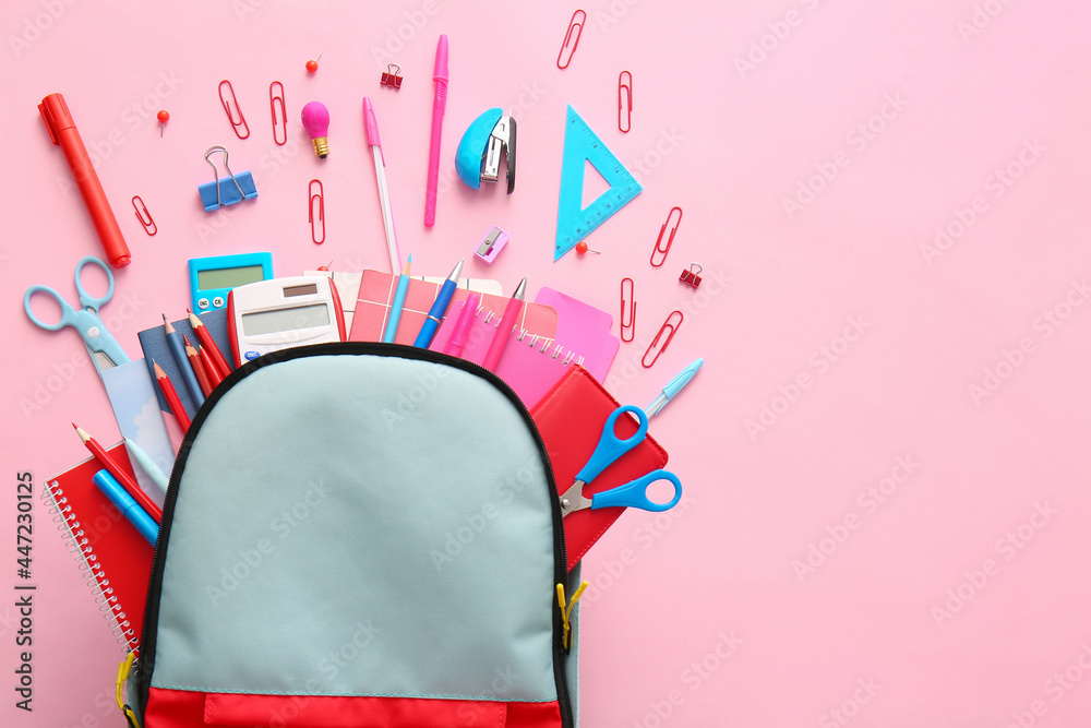 School backpack and stationery on color background - obrazy, fototapety, plakaty 