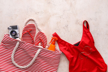 Set of beach accessories on light background