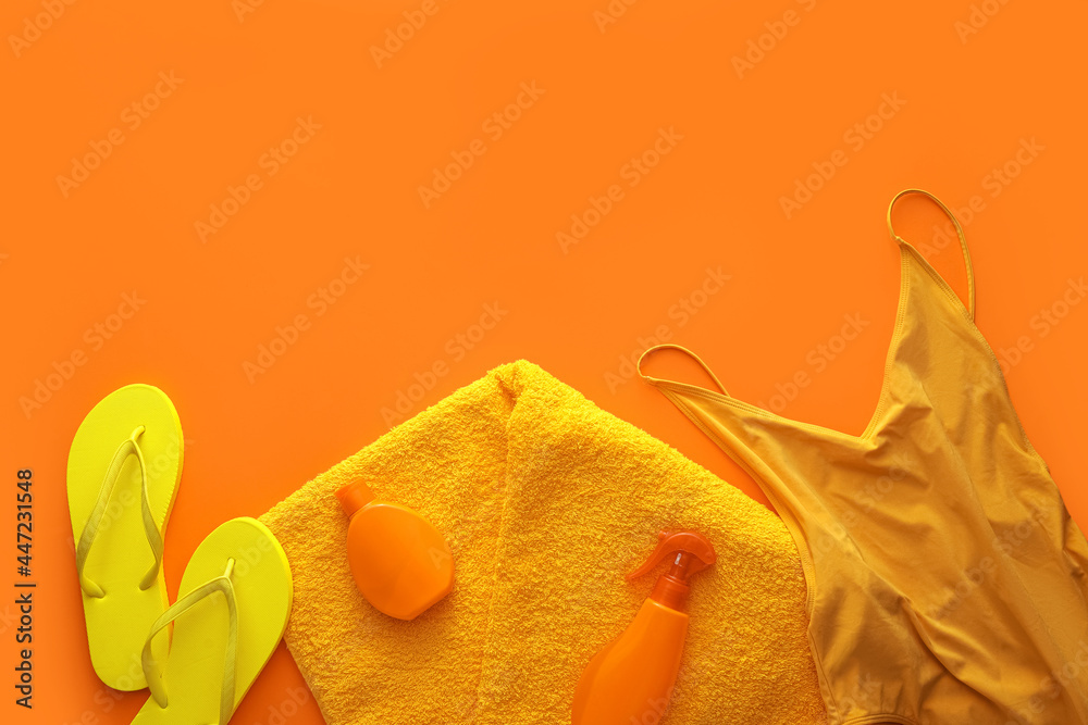 Set of beach accessories on color background