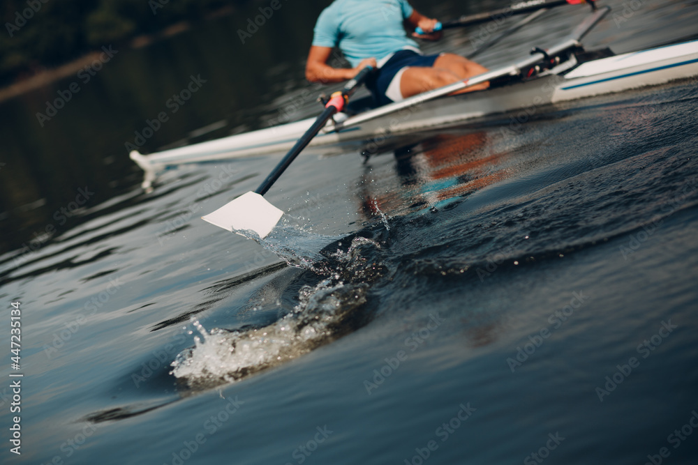 Sportsman single scull man rower rowing at competition boat regatta. Close up paddle splash water - obrazy, fototapety, plakaty 
