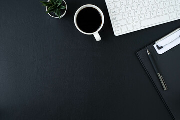 Wall Mural - Black leather office desk table. Workspace with computer white keyboard and blank notebook, pen with equipment other office supplies. Top view with copy space, flat lay.