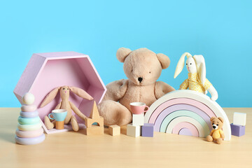 Sticker - Many different toys on wooden table against light blue background