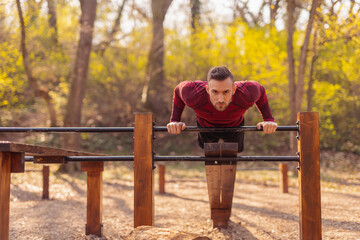 Wall Mural - Man working out in street workout park, doing push ups