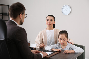 Mother and daughter having meeting with principal at school