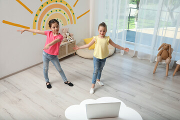 Wall Mural - Cute little girls taking online dance class at home