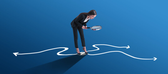 Poster - Young european businesswoman with magnifier and arrows on blue background. Success, leadership, choice and direction concept.