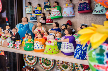 Traditional souvenirs of Otranto, Apulia, Italy. Colorful ceramic figures of women. Gifts from Puglia