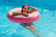 © Image'in - pretty young woman in the swimming pool with her inflatable buoy
