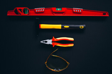 Wall Mural - Set of tools with eyewear protection glasses isolated on black background