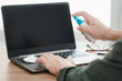 © NongAsimo - Hand a man cleaning and disinfection of workspace. Disinfecting wipes to wipe surface of desk, keyboard laptop, mouse at office. Stop the spread