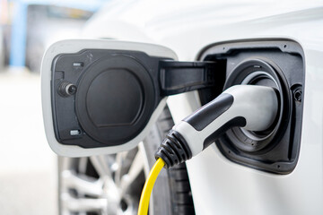 Old Electric supply plug for Electric car with power supply in a car charging station