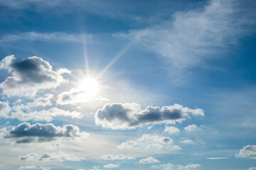 Wall Mural - the light of the sun shining through the clouds in the sky