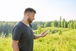 © Valerii Honcharuk - Middle-aged bearded man with backpack using smartphone