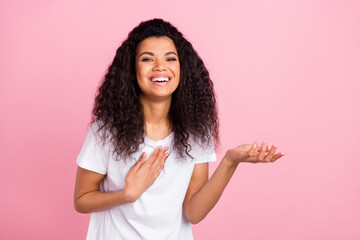 Wall Mural - Photo of funny charming dark skin woman dressed white outfit laughing holding arm empty space isolated pink color background