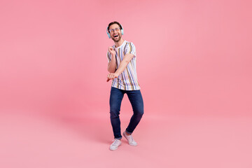 Sticker - Full body photo of cheerful young happy positive man wear headset dance enjoy isolated on pink color background