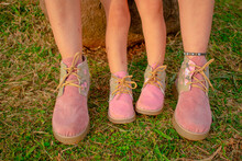 Closeup Shot Of A Mother And Daughter Wearing Matching Shoes
