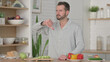 © stockbakers - Man Showing Thumbs Down while Standing in Kitchen
