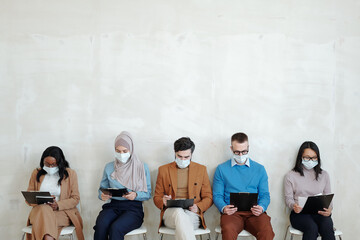 Poster - Young multiracial applicants waiting for their turn for interview against white wall