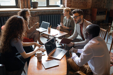 Aufkleber - Two groups of co-workers discussing new ideas at meeting