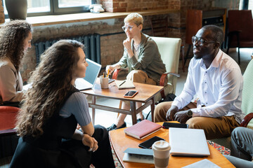 Aufkleber - Intercultural co-workers brainstorming and discussing new ideas