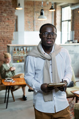 Poster - Young male professional with notebook looking at you against female colleague