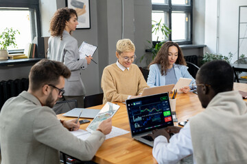 Aufkleber - Group of co-workers using mobile gadgets during individual work by table in office