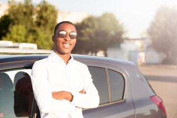 Wall Mural - happy african american next to a car in the summer