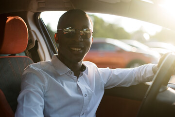 Wall Mural - happy african american driving a car, in the summer