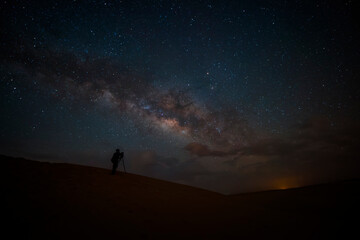 Wall Mural - Night landscape with colorful Milky Way in deserts. Starry sky with hills at summer. Beautiful Universe. Space background..