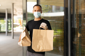 Wall Mural - delivery guy in protective mask near the customer house, outdoors.